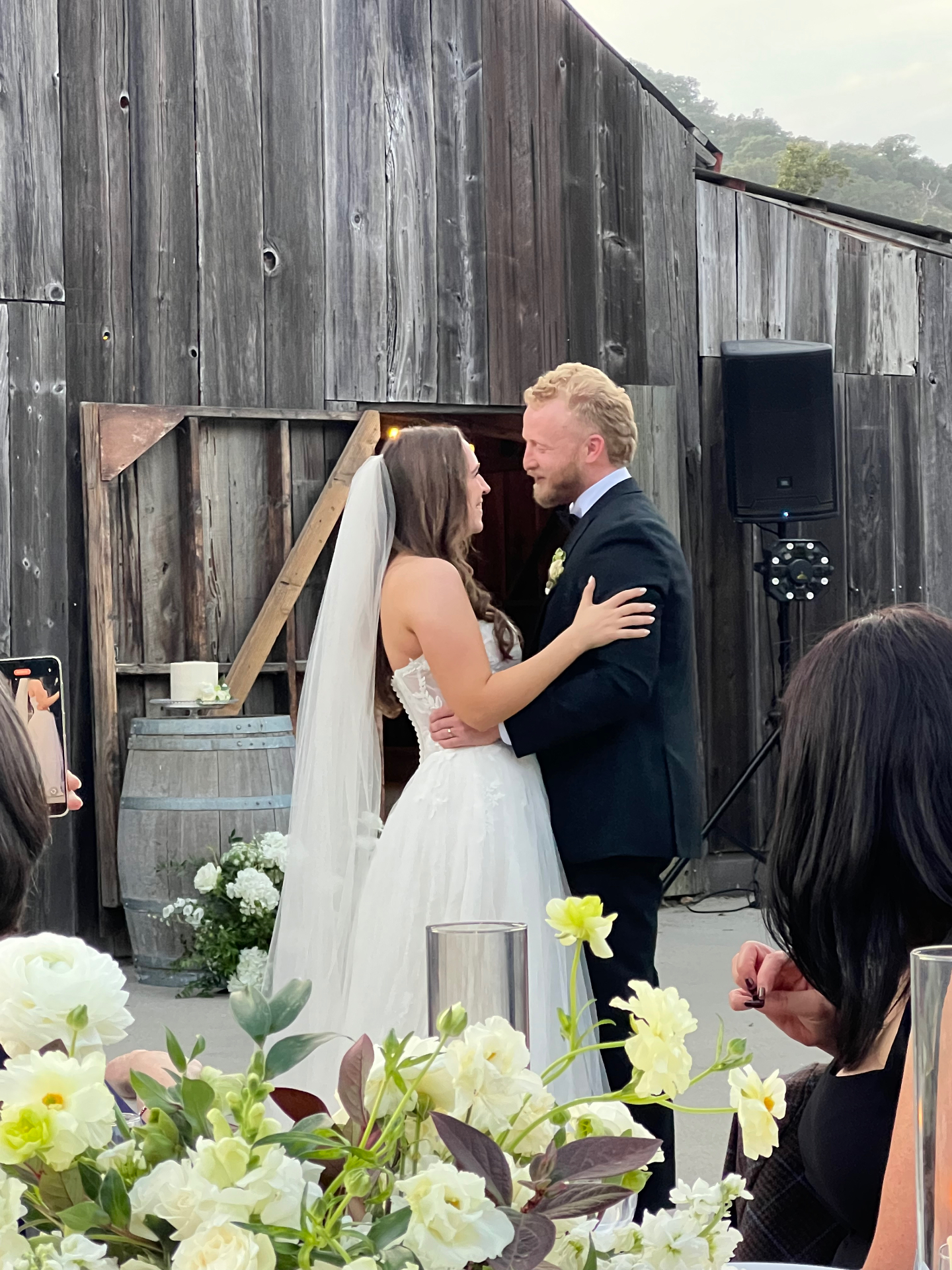 Bride and groom sharing their first dance at a rustic barn wedding