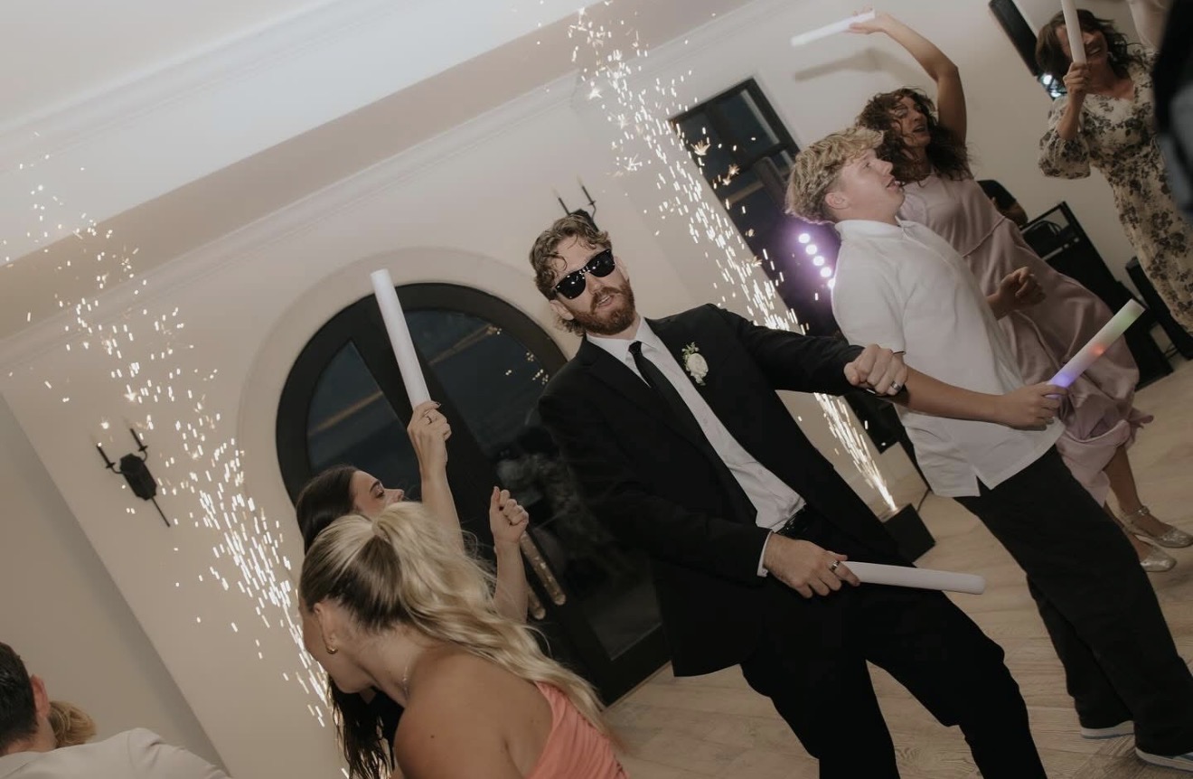 Guests dancing under cold sparks at a wedding reception